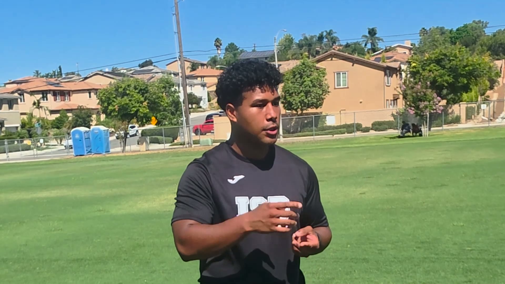 ISD Academy coach explaining the player development tracking platform